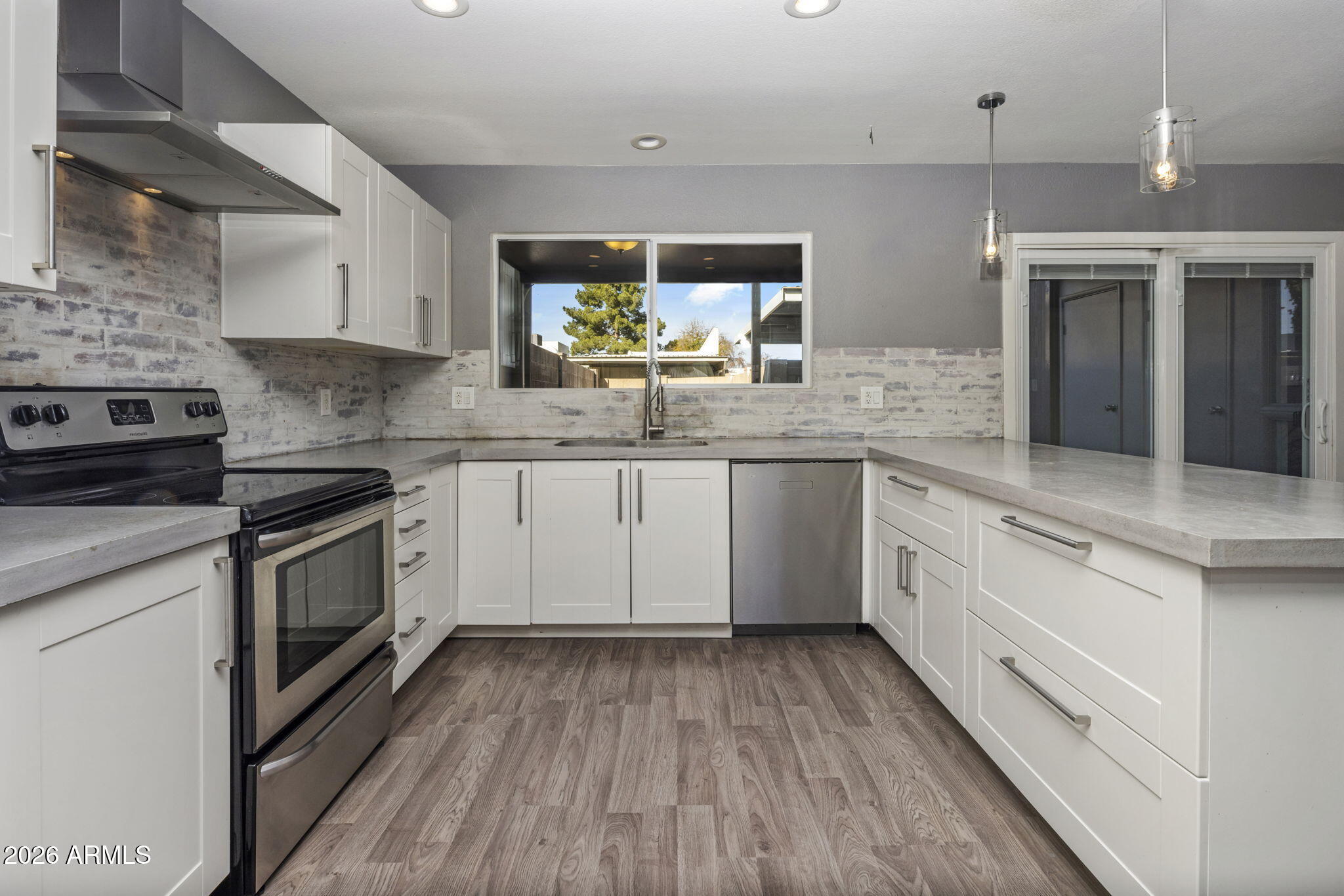 1842 West Marlette Avenue Phoenix, AZ 85015 - Photo 6 of 30 a kitchen with granite countertop a sink cabinets stainless steel appliances and a counter space