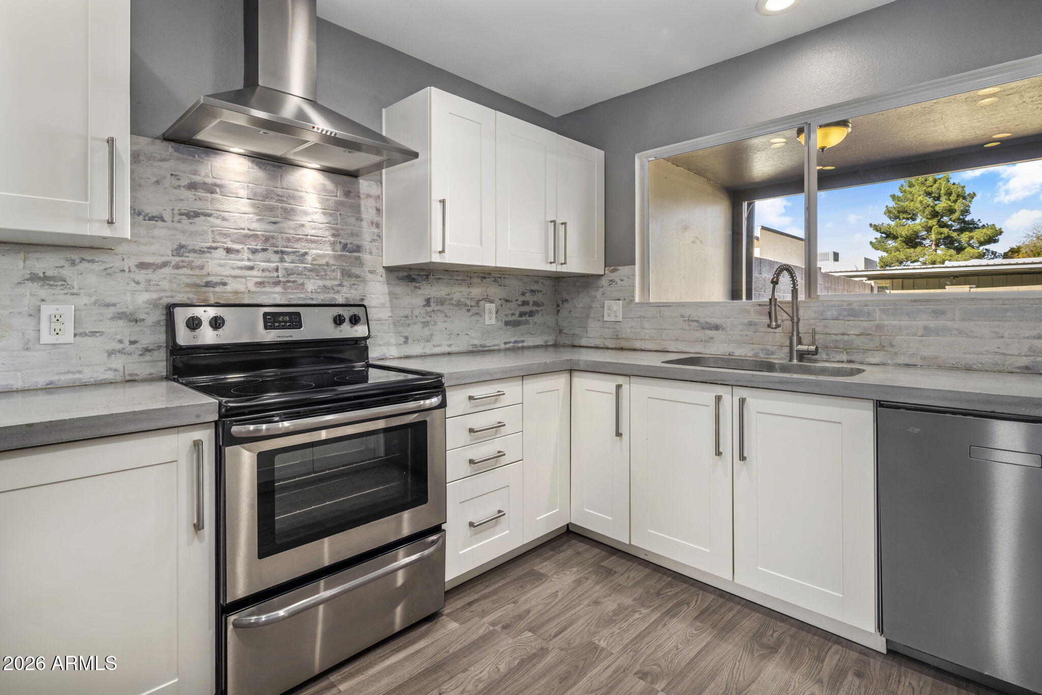 1842 West Marlette Avenue Phoenix, AZ 85015 - Photo 7 of 30 a kitchen with granite countertop a stove sink and cabinets