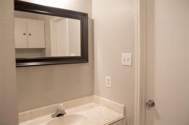 a bathroom with a sink and a mirror