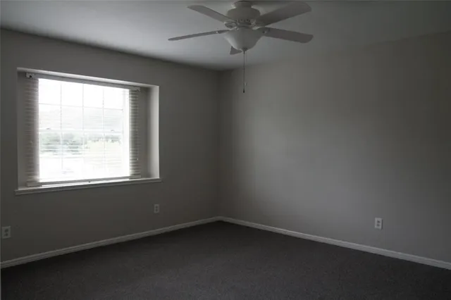 en empty room with a fan