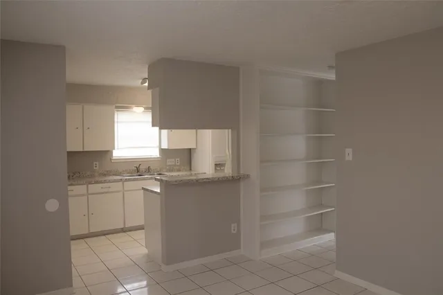 a kitchen with a sink cabinets and window