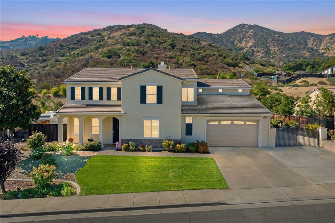 20439 Fox Den Road Wildomar, CA 92595 - Photo 1 of 1 a front view of a house with a garden and a yard