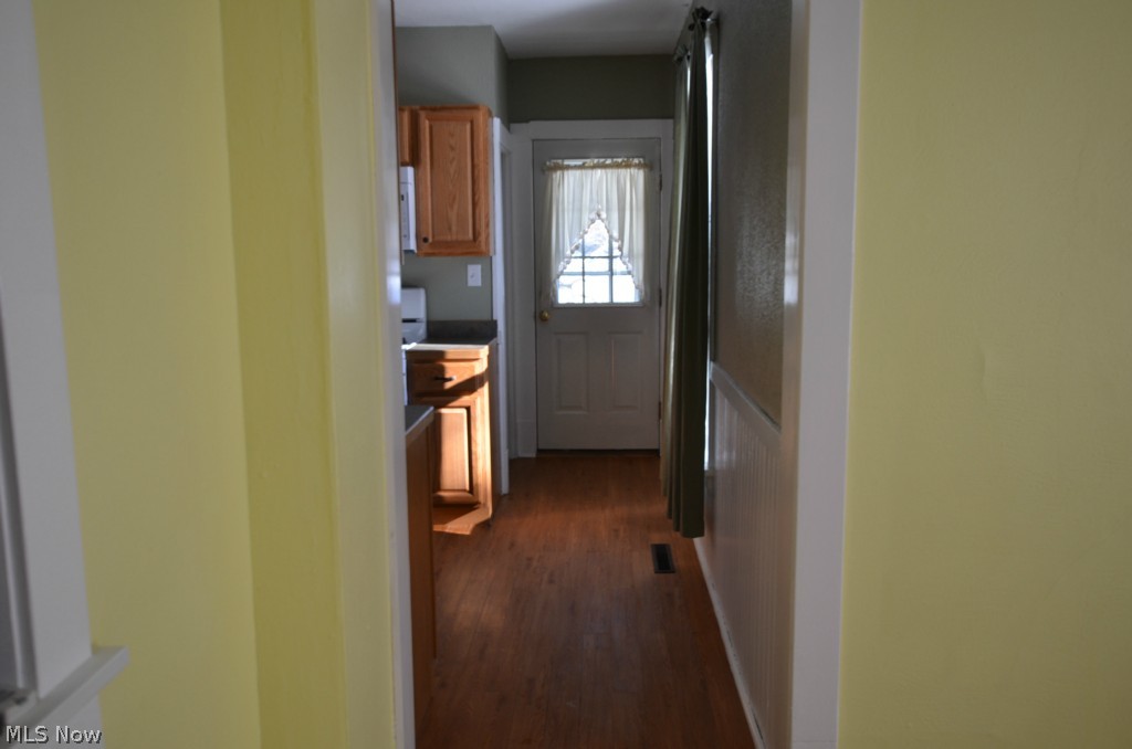 3816 State Road Ashtabula, OH 44004 - Photo 18 of 25 New flooring in Kitchen. Hallway leads to basement and back door access to privacy fencing and spacious garage.