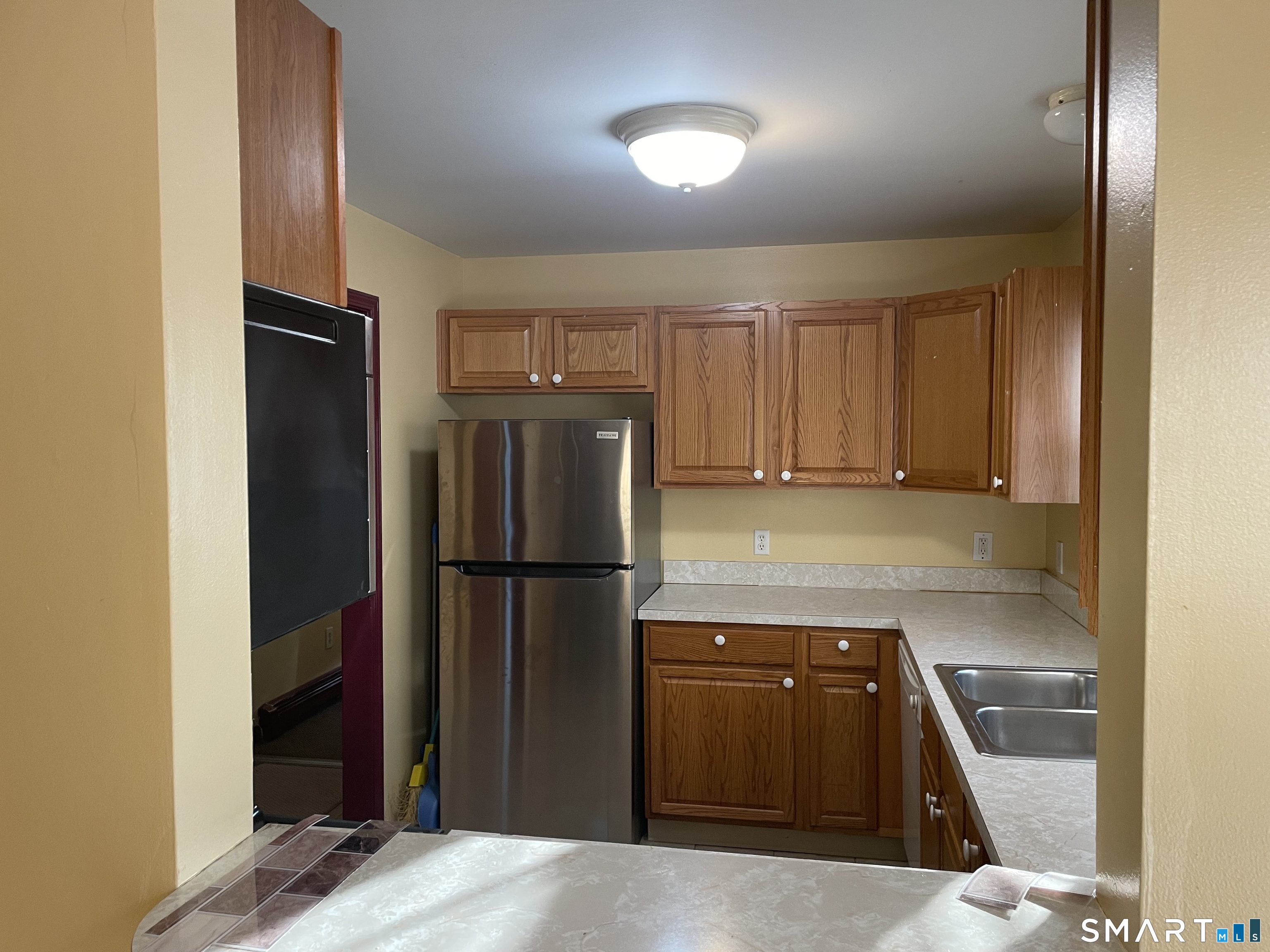 11 Button Street New Haven, CT 06519 - Photo 7 of 18 a kitchen with a refrigerator and a stove