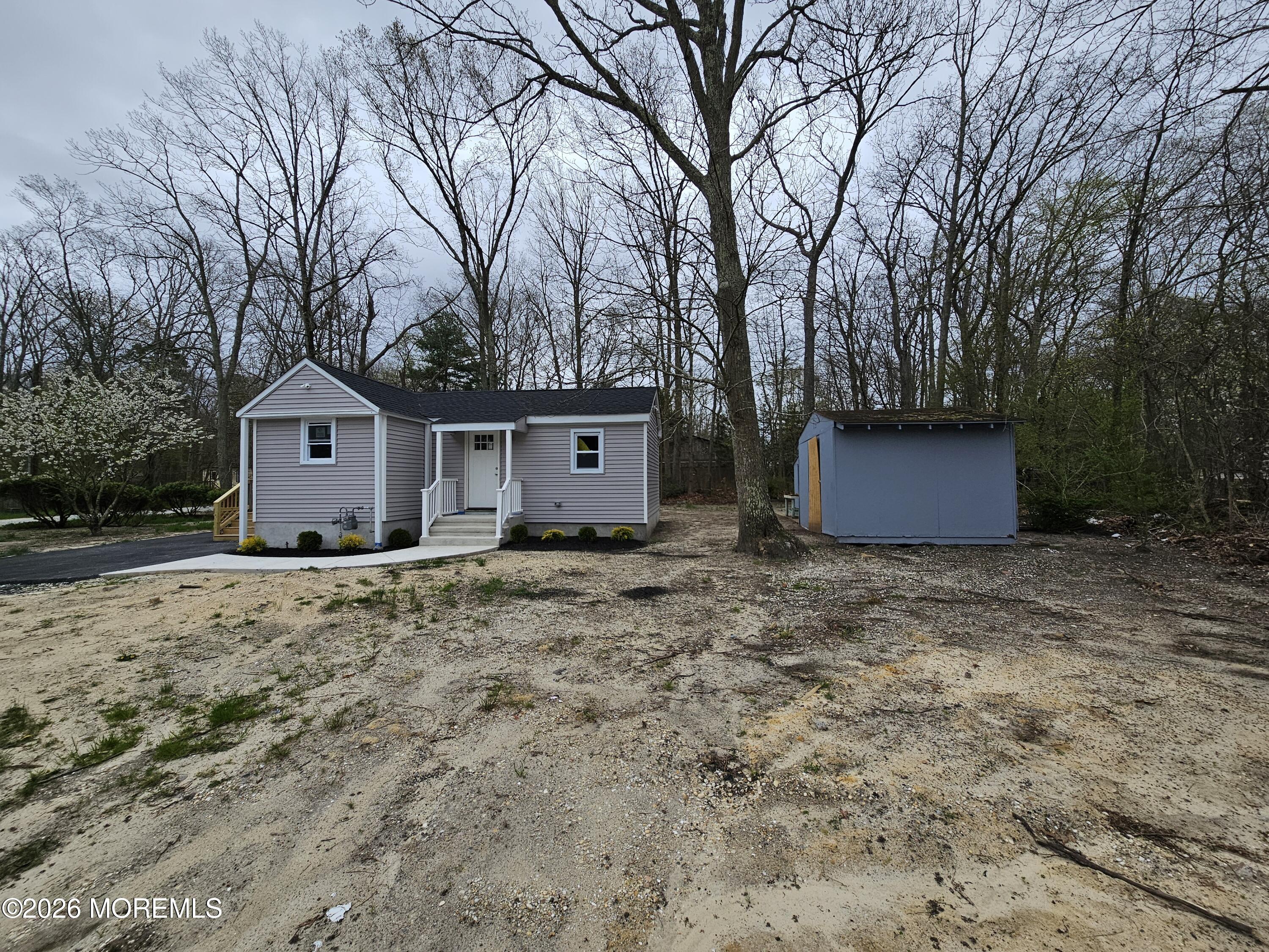 6611 Magnolia Drive Millville, NJ 08332 - Photo 2 of 14 a house with trees in front of it