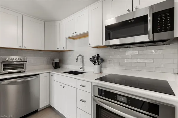 a kitchen with a sink and cabinets