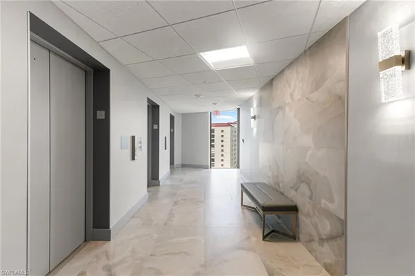 a view of a hallway with seating area