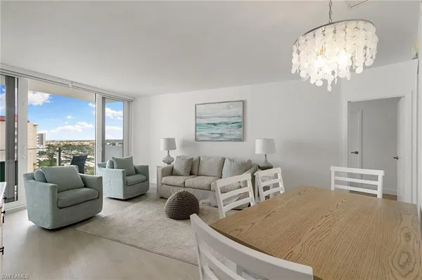 a living room with furniture and a chandelier
