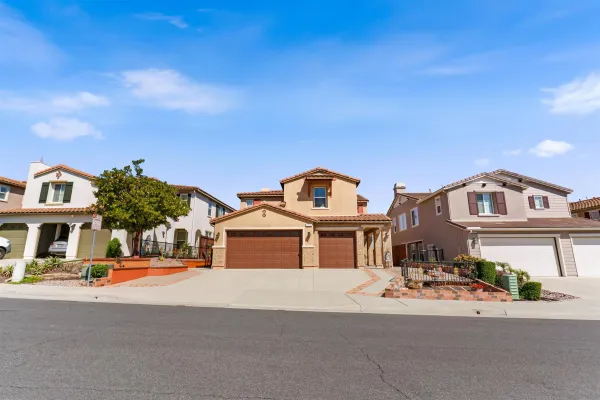 a dining room with furniture potted plants and wooden floor