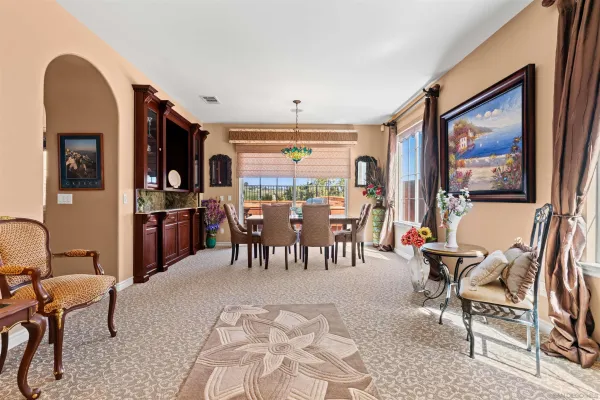 a living room with furniture and chandelier