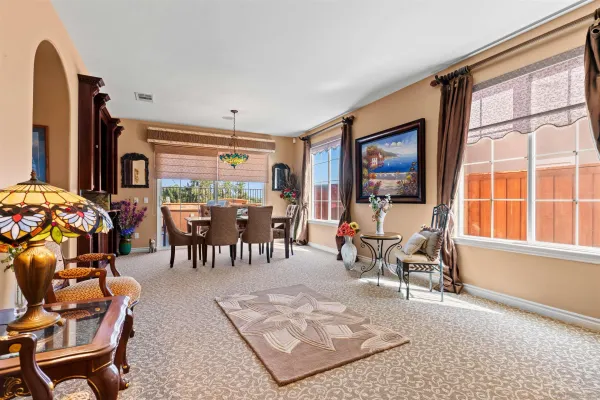 a living room with furniture a fireplace and a large window