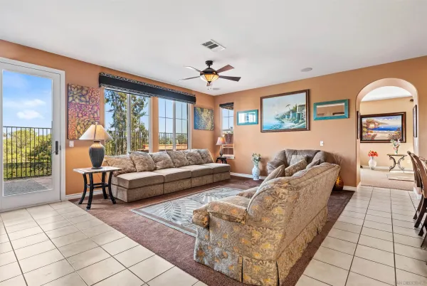 a living room with fireplace furniture and a potted plant