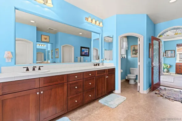 a bathroom with a double vanity sink and a mirror