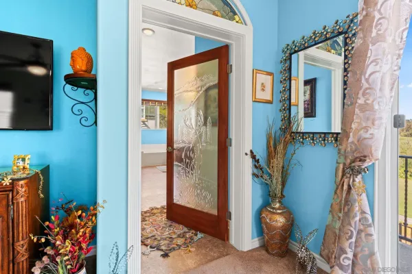 an aerial view of a house with a yard and large trees