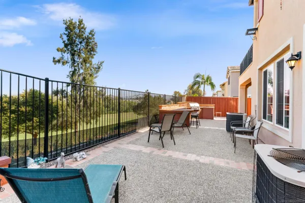an aerial view of residential houses with outdoor space and ocean view