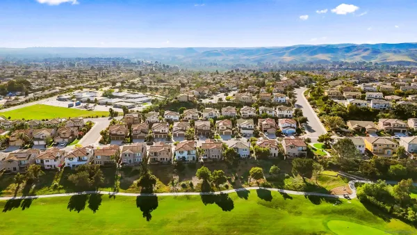 a front view of a residential apartment building with a yard