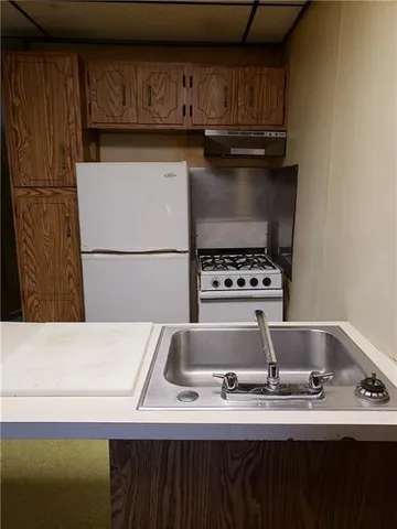 a kitchen with a sink a stove and refrigerator