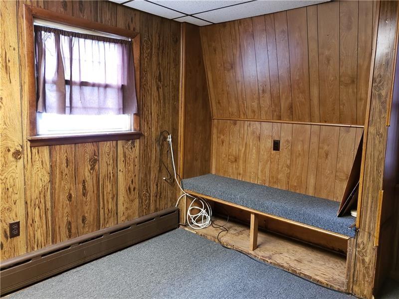 1120 East Swissvale Avenue, Unit 3 FRONT Pittsburgh, PA 15221 - Photo 7 of 14 a bench sitting in wooden floor next to a window