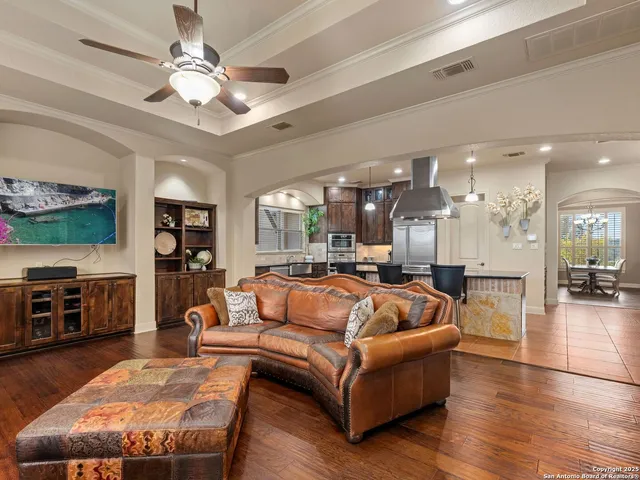 a living room with furniture a wooden floor and a fireplace