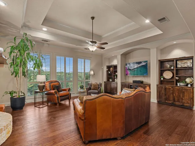 a kitchen with stainless steel appliances granite countertop a sink a counter space and living room view