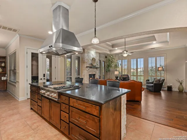 a kitchen with granite countertop a refrigerator and a sink