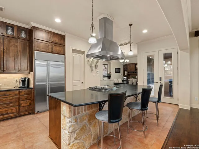 a kitchen with stainless steel appliances granite countertop a refrigerator and a stove