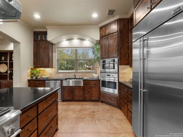 a stove top oven sitting inside of a kitchen