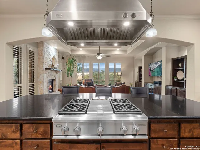 a view of a dining room with furniture a chandelier and wooden floor