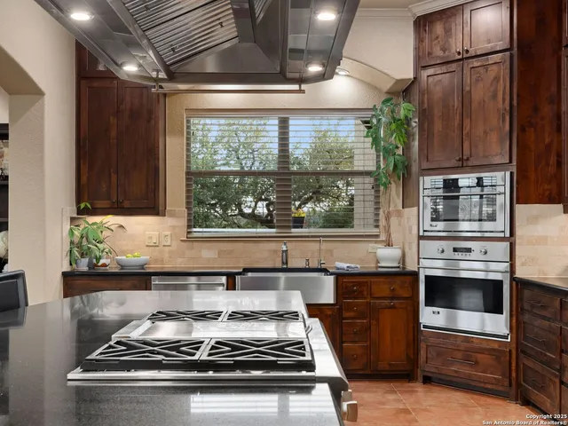 a view of a dining room with furniture large window and chandelier