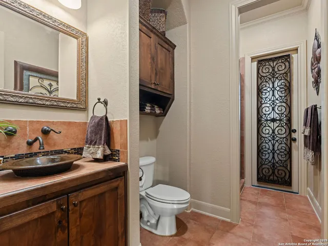 a bedroom with a bed and a mirror on the dresser