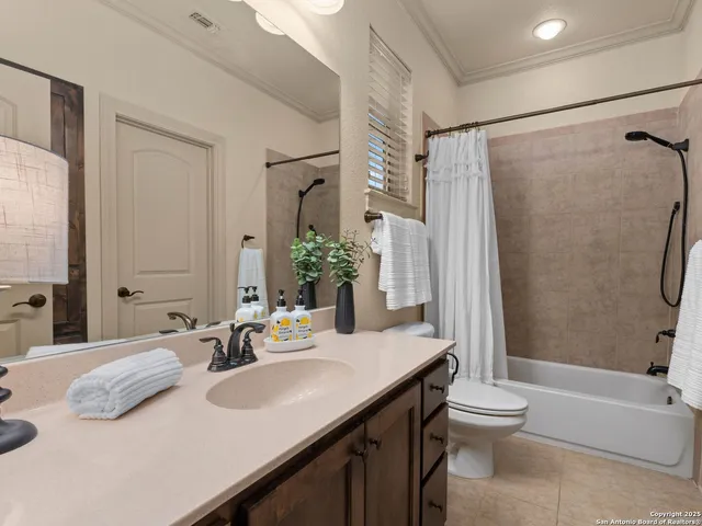 a dining room with furniture a rug and a chandelier