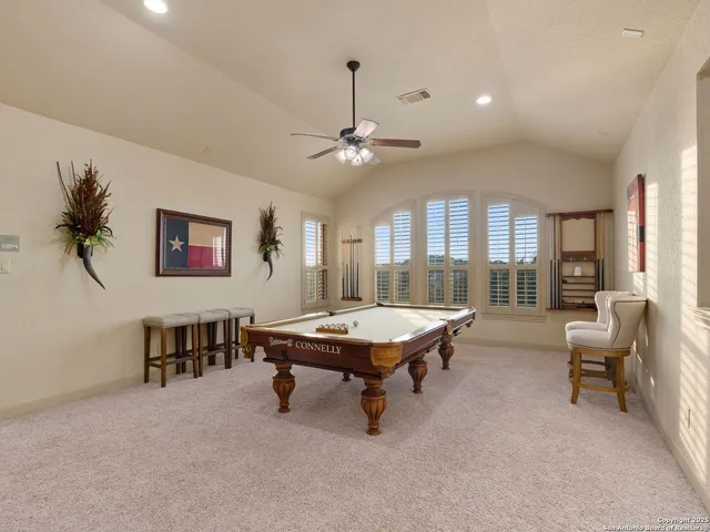 an aerial view of a house with a garden and lake view