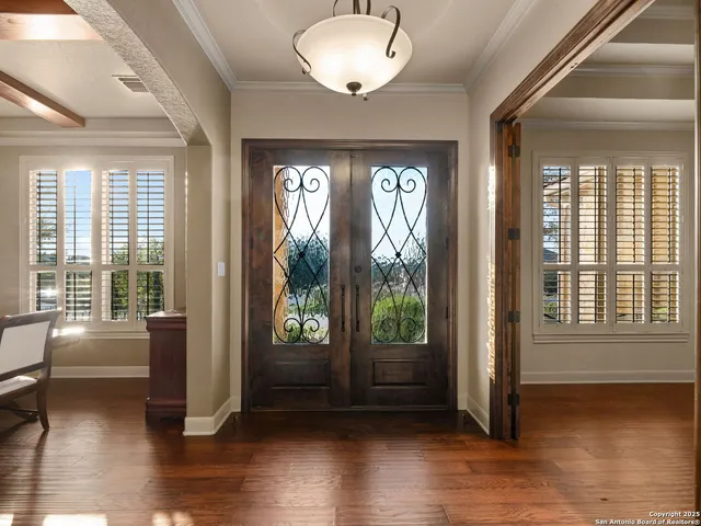 a view of an entryway with wooden floor and door
