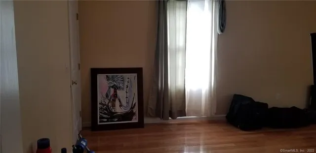 an empty room with wooden floor and closet