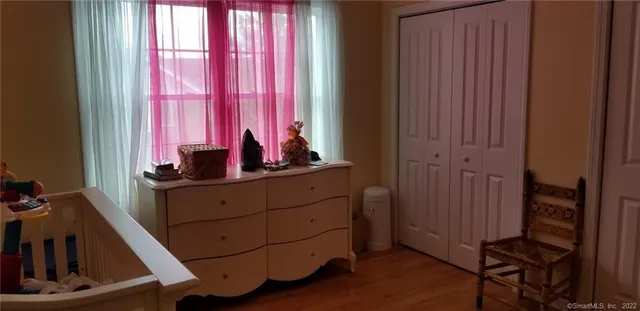 a room with wooden floor and furniture