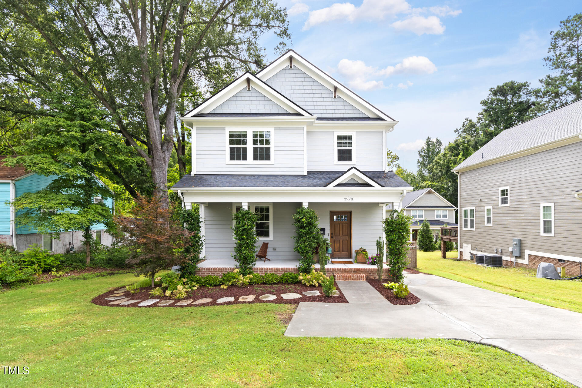 a front view of a house with a yard table and chairs
