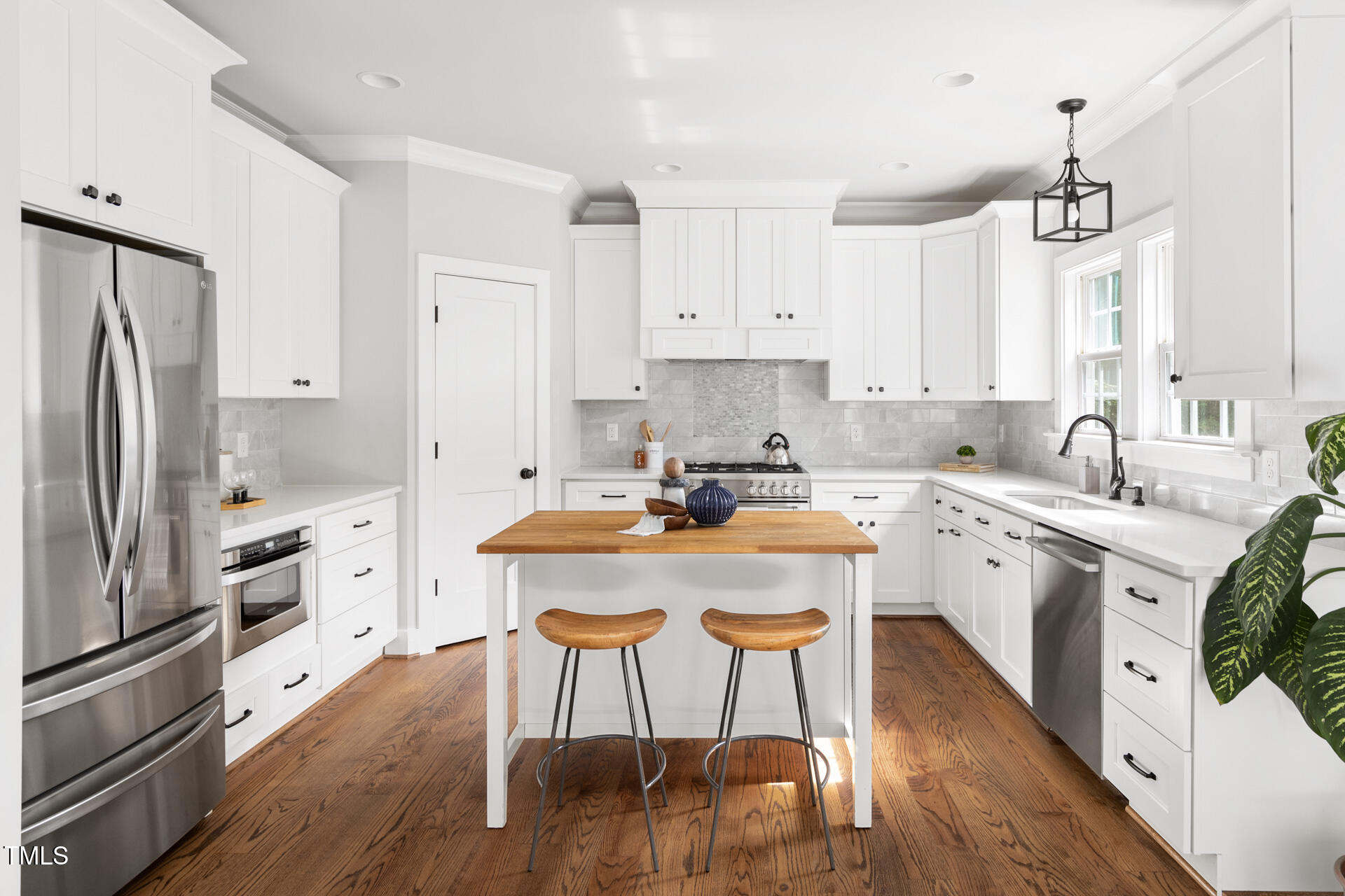 2929 Chapel Hill Road Durham, NC 27707 - Photo 15 of 38 a kitchen with stainless steel appliances granite countertop a white cabinets and wooden floor