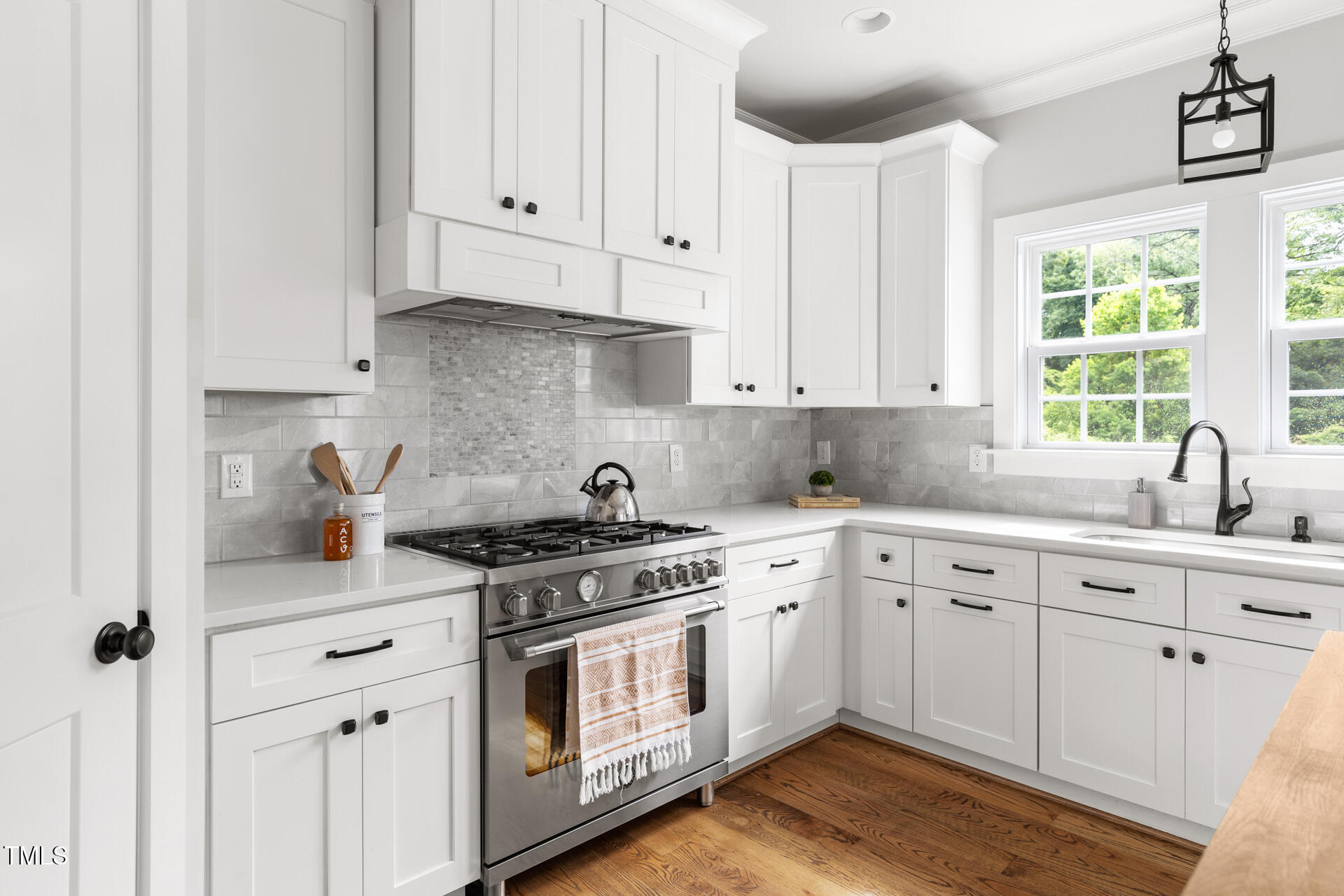 2929 Chapel Hill Road Durham, NC 27707 - Photo 18 of 38 a white kitchen with granite countertop white cabinets and white appliances