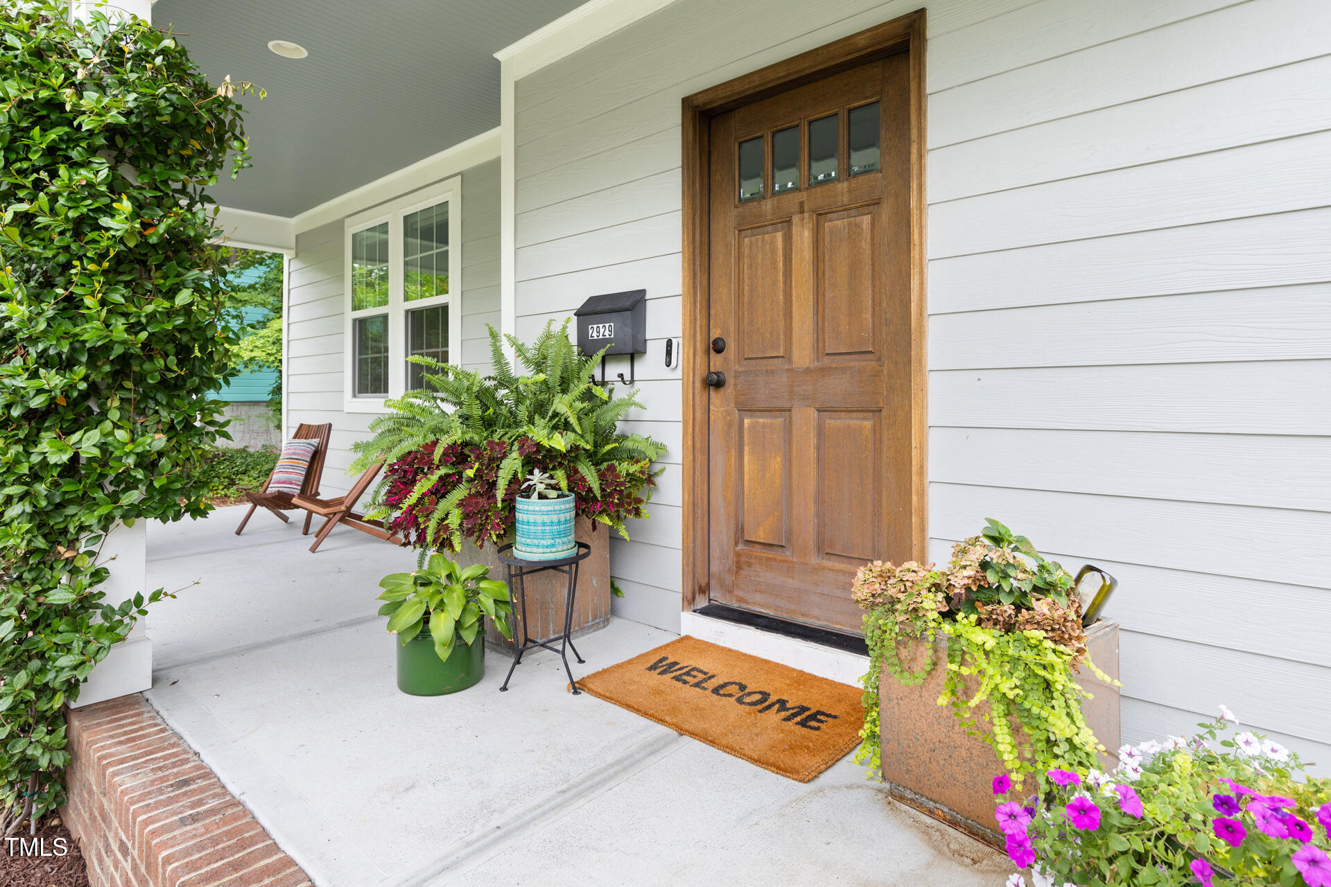 2929 Chapel Hill Road Durham, NC 27707 - Photo 5 of 38 a vase of flowers sitting on a floor in front of a door