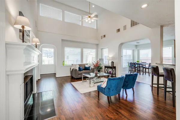 a living room with fireplace furniture and a wooden floor