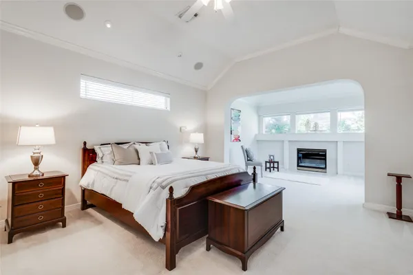 a spacious bedroom with a bed and a fireplace