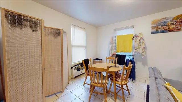 a view of a dining room with furniture and a chandelier