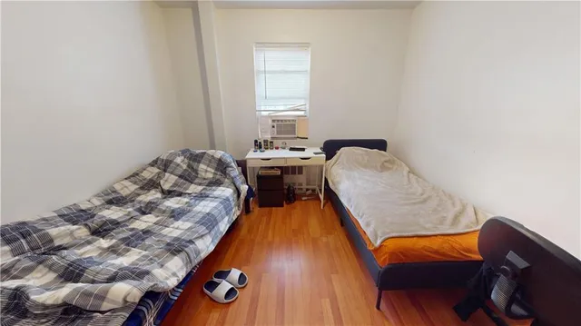 a view of a bedroom with furniture and window