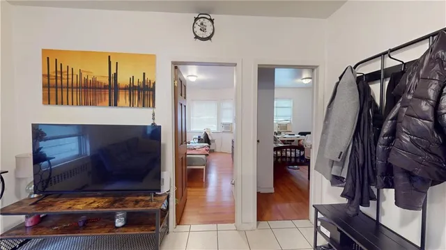 a living room with stainless steel appliances kitchen island granite countertop furniture a rug and a window