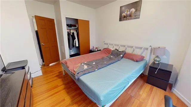 a bed sitting in a bedroom next to a window