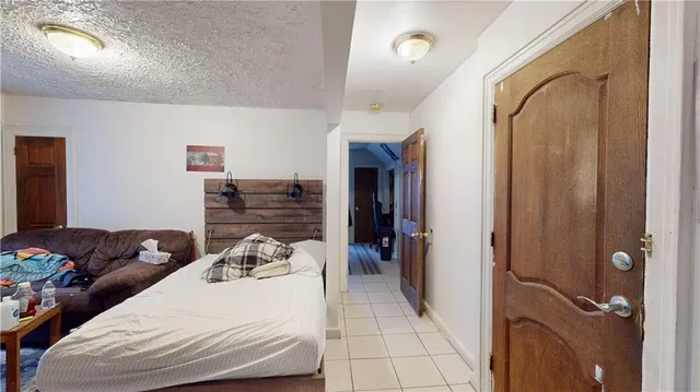 a bedroom with bed and a chandelier