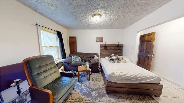 a bedroom with furniture and a window