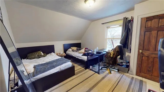 a bedroom with furniture and a wooden floor