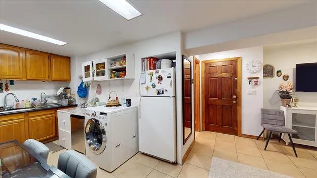 a view of a kitchen with fridge and workspace