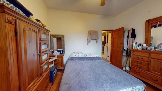 a view of a hallway with wooden floor and stairs